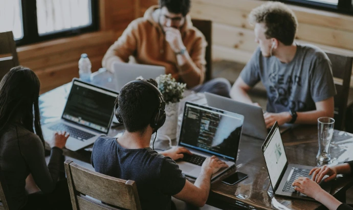group of people using laptop computer